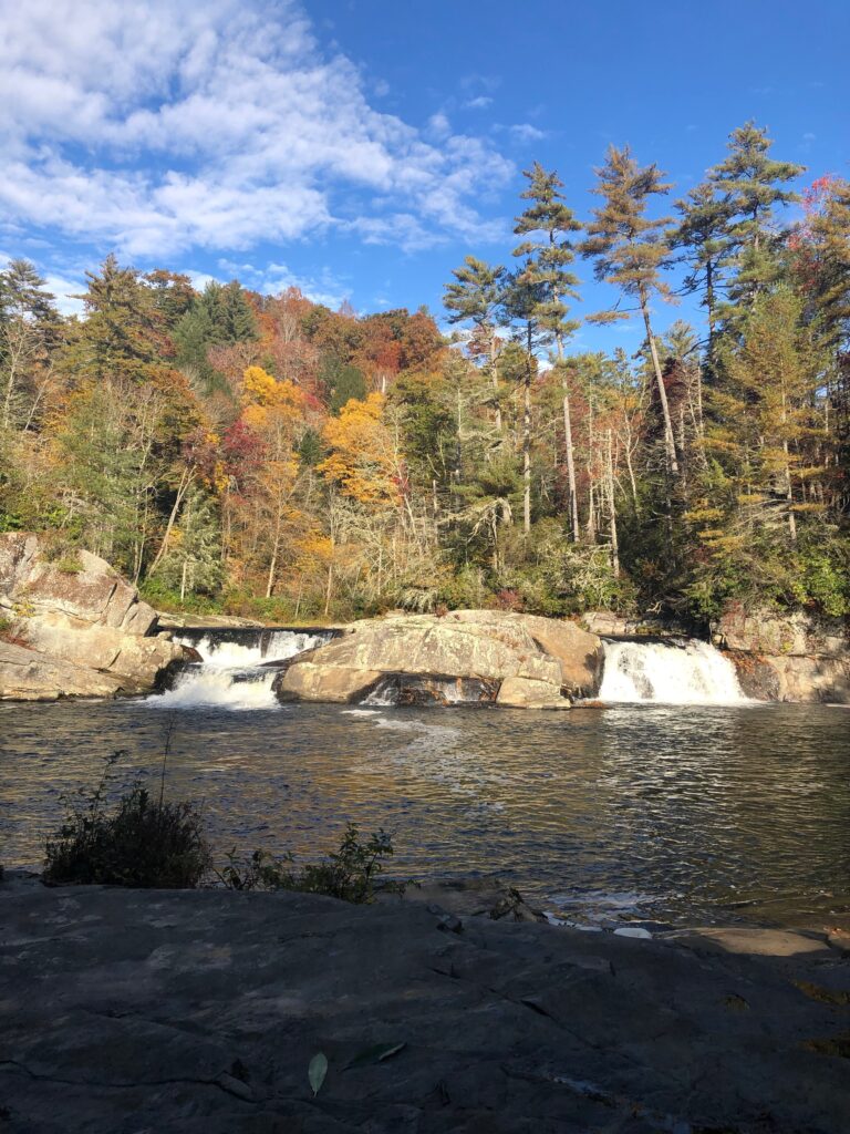 Photo of Linville Falls depicting two cascading waterfalls in the autumn season.