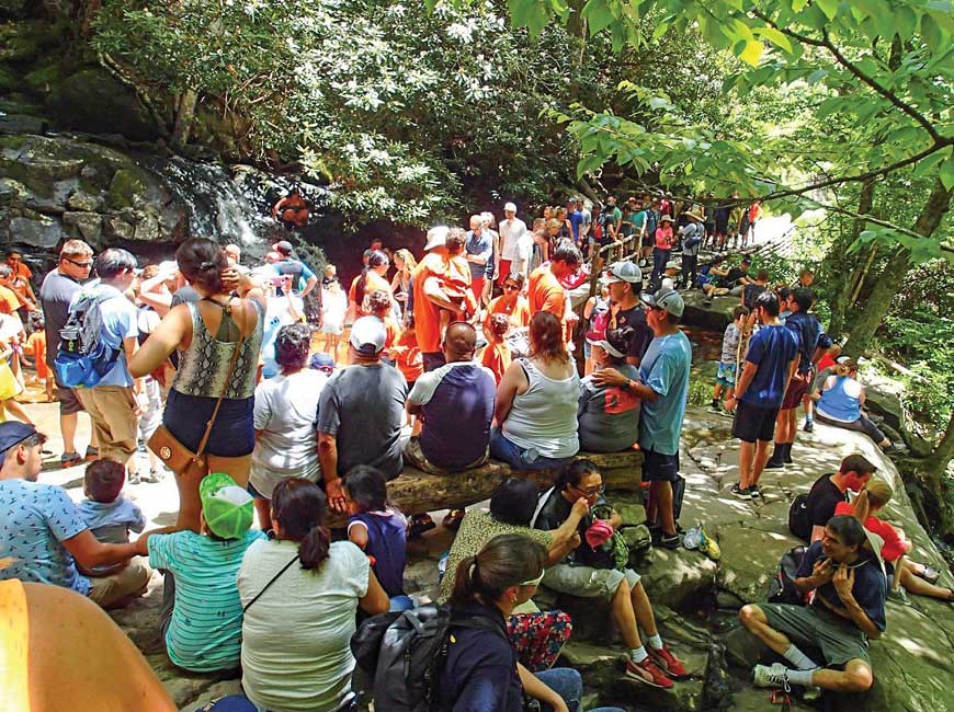 People standing shoulder to shoulder at Laurel Falls in the Smoky Mountains.